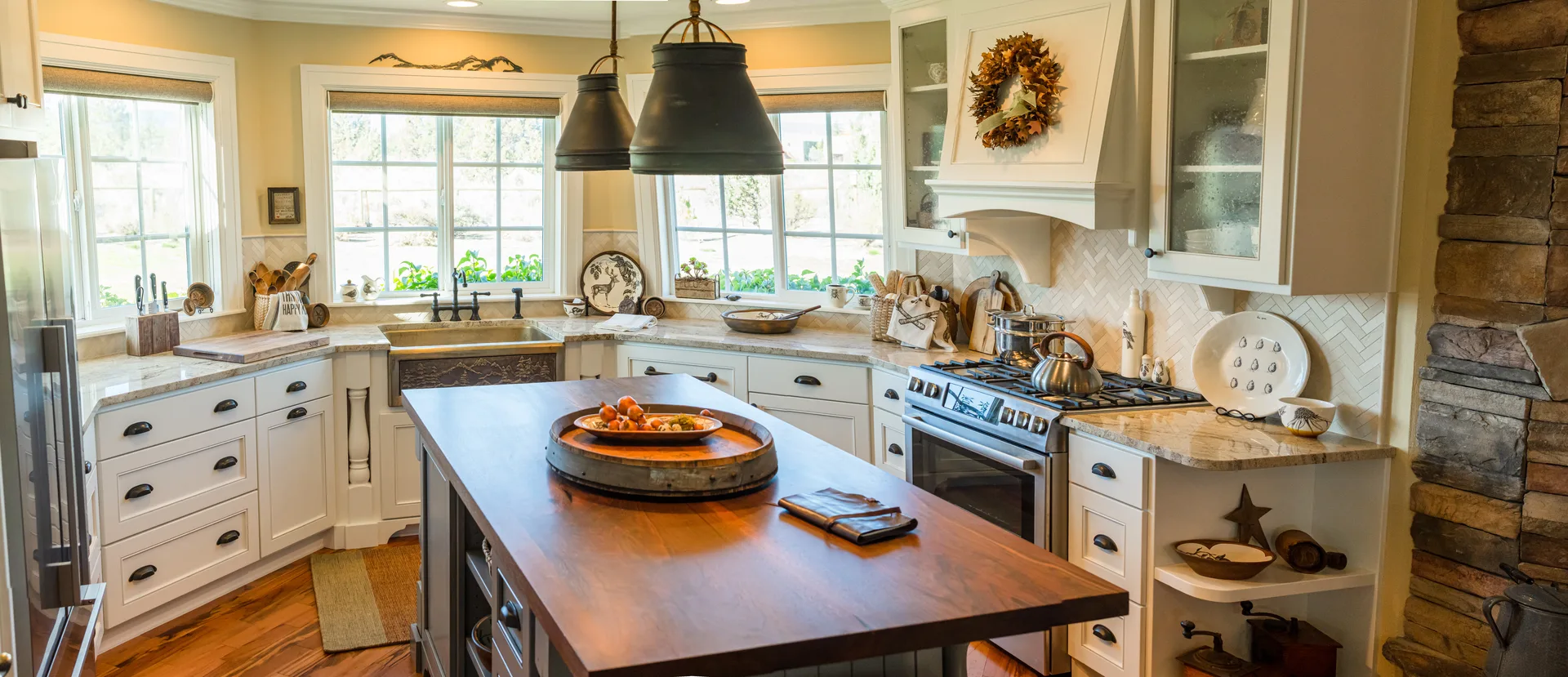 Marble farmhouse kitchen with walnut island