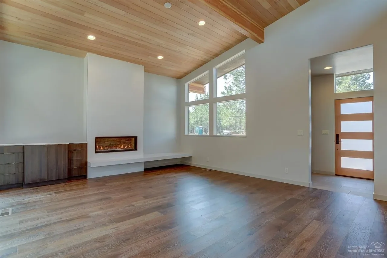 Great room with linear gas fireplace and wood plank ceiling
