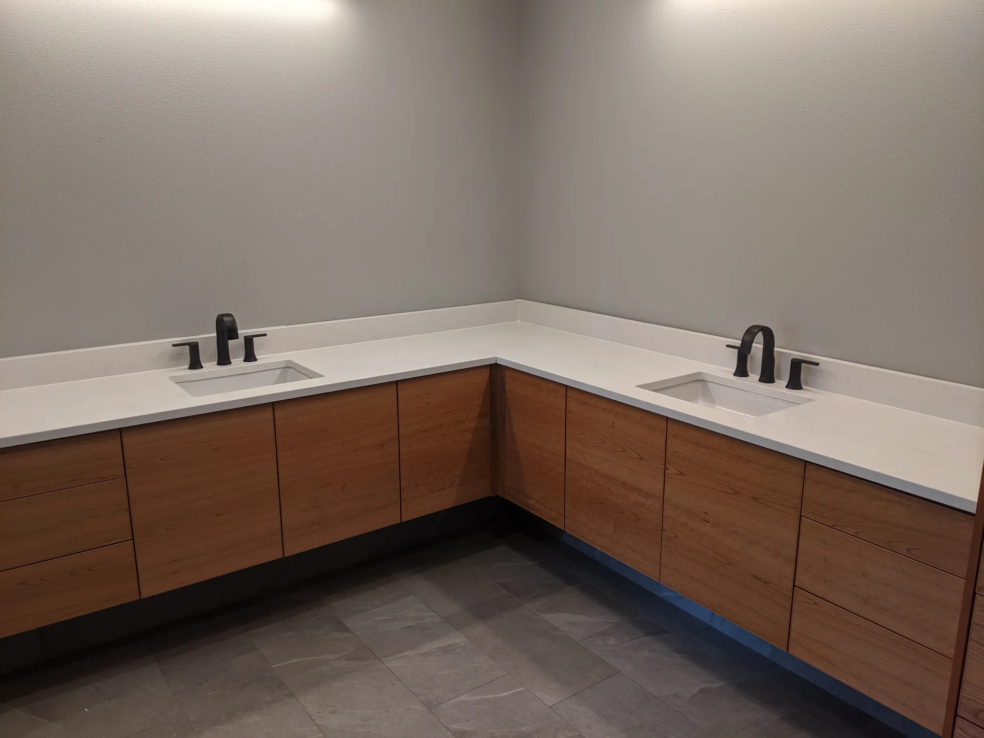 White quartz L-shaped floating wood vanity
