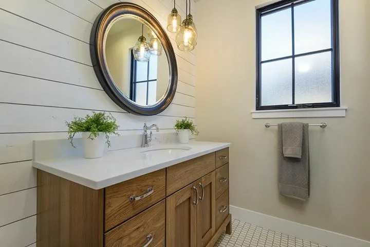 White quartz bathroom vanity with shiplap wall and wood cabinet