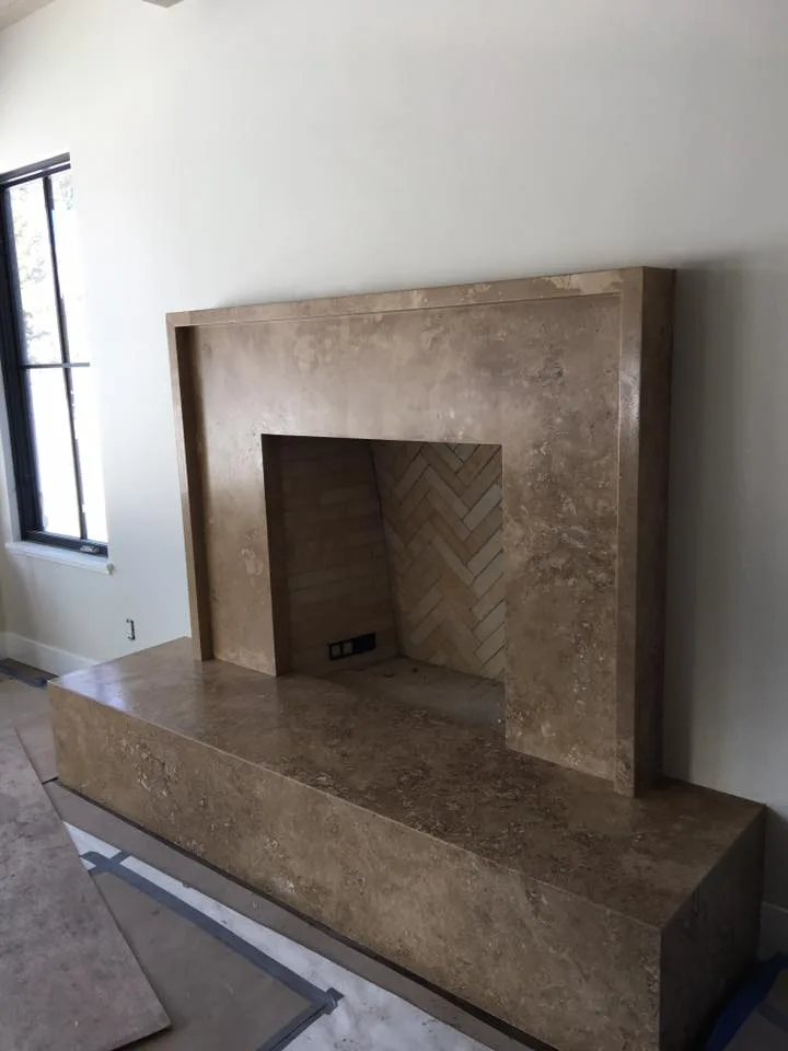 Travertine fireplace surround with herringbone firebox