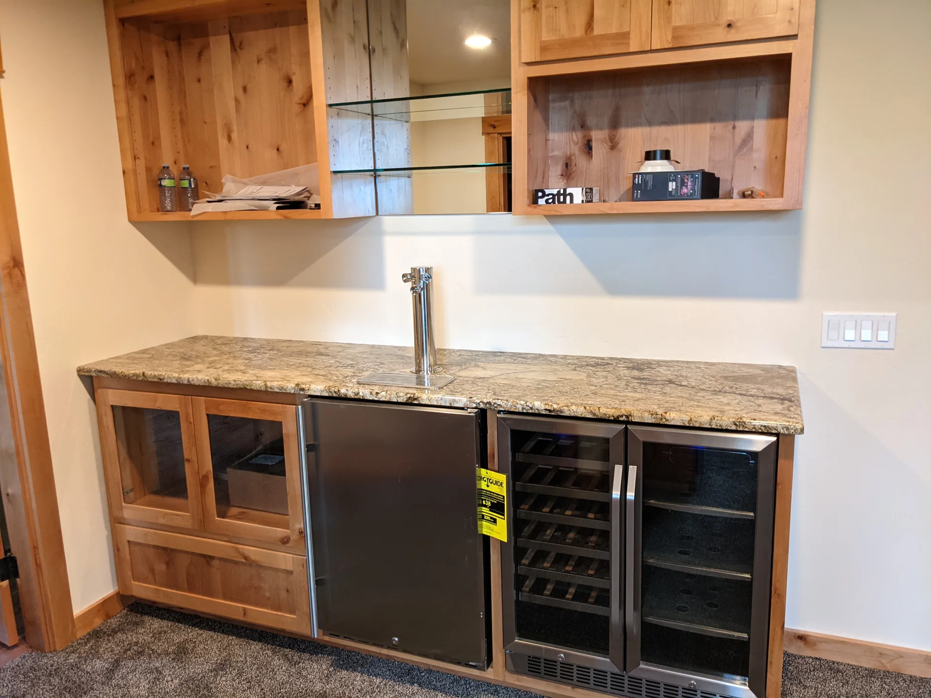 Granite basement bar countertop with kegerator and wine fridge