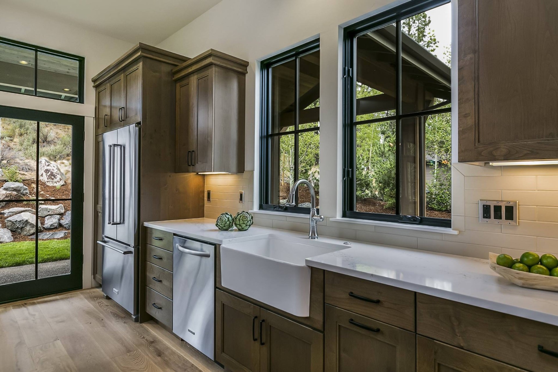 Custom kitchen with quartz countertops and farmhouse sink by Solid Rock